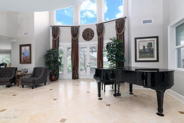 miscellaneous room featuring a towering ceiling