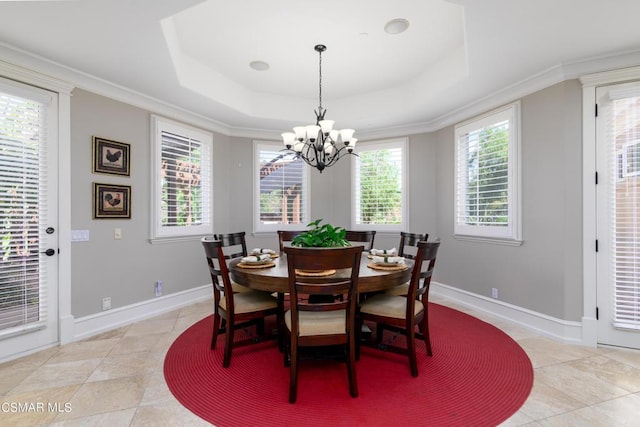 dining room with a raised ceiling, crown molding, light tile patterned flooring, and a notable chandelier