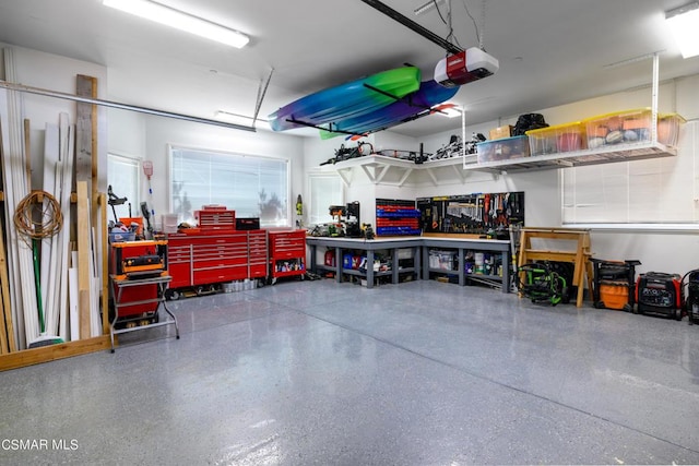 garage featuring a garage door opener and a workshop area