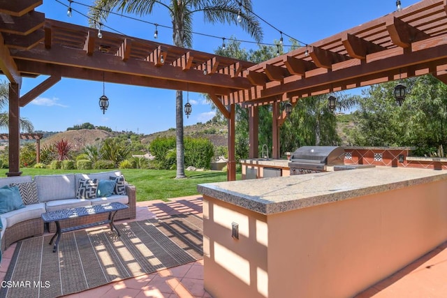 view of patio featuring a pergola, outdoor lounge area, an outdoor wet bar, grilling area, and exterior kitchen