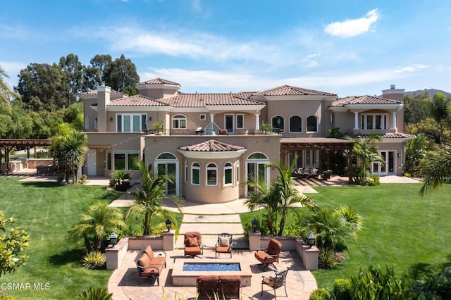 back of property featuring a yard, a pergola, and a patio