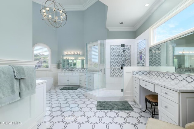 bathroom with vanity, crown molding, separate shower and tub, and an inviting chandelier