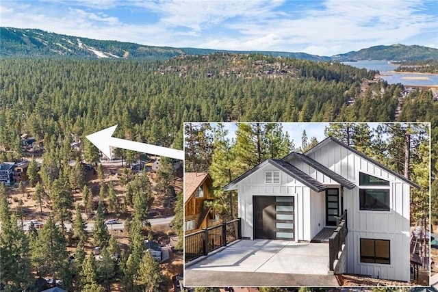 birds eye view of property with a water and mountain view