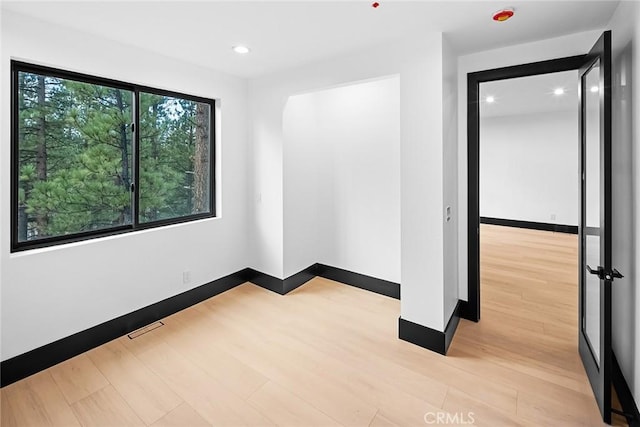 spare room with light wood-type flooring