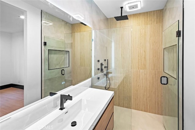 bathroom featuring tile patterned floors, vanity, and an enclosed shower