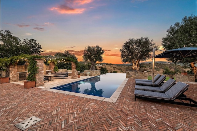 pool at dusk with a patio