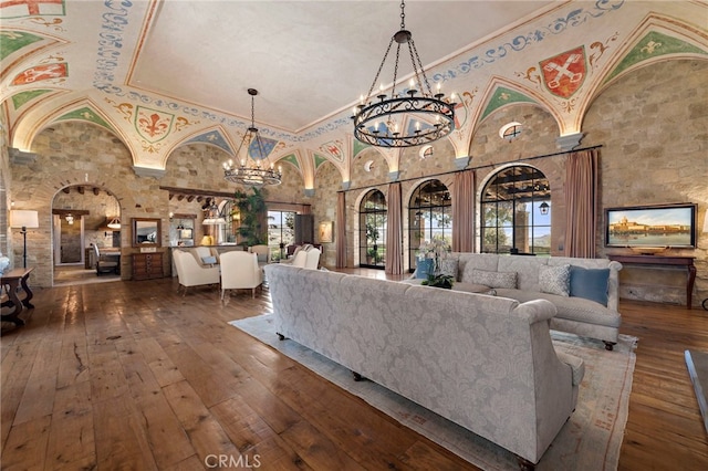 living room featuring a notable chandelier, high vaulted ceiling, and dark wood-type flooring