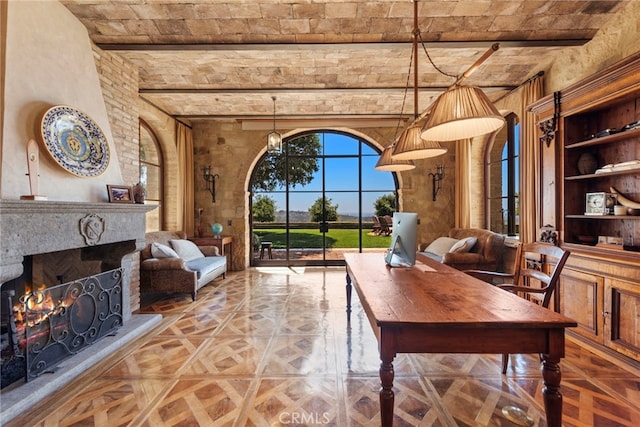 living room featuring beamed ceiling, built in features, and parquet floors