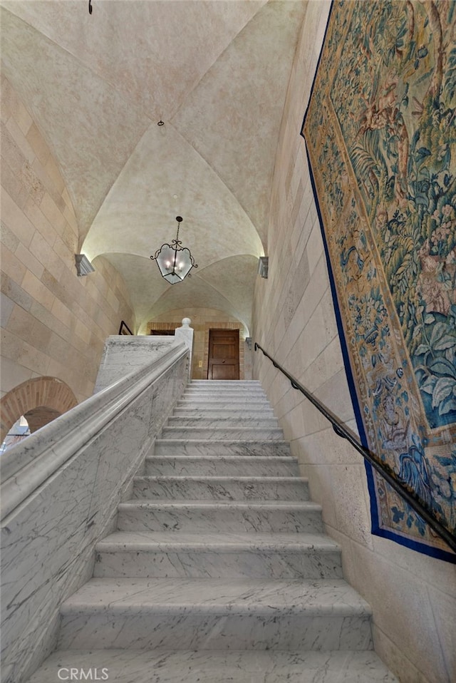 stairway with lofted ceiling