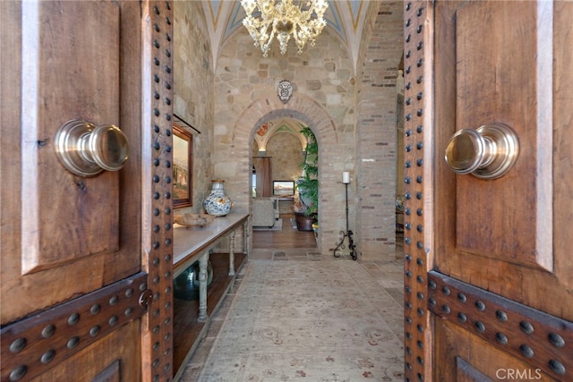 bathroom featuring vaulted ceiling and a notable chandelier