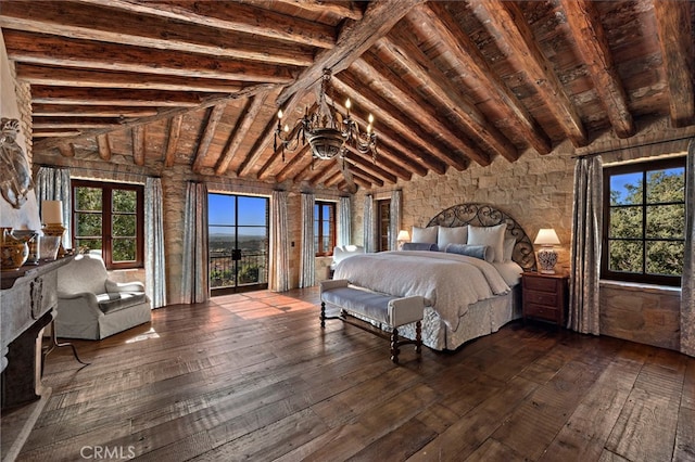 bedroom with lofted ceiling with beams, dark hardwood / wood-style flooring, and multiple windows