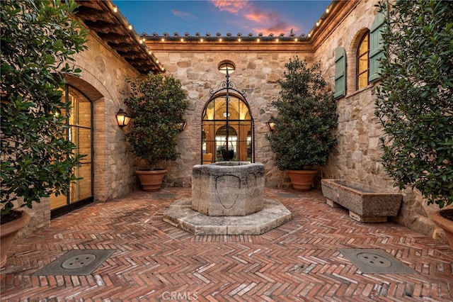 patio terrace at dusk featuring french doors