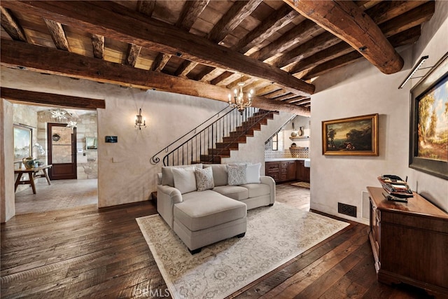 living room featuring beamed ceiling and dark hardwood / wood-style flooring