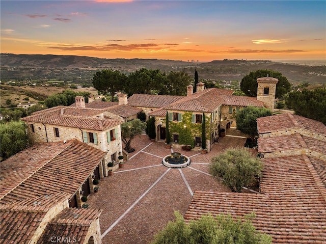 aerial view at dusk featuring a mountain view