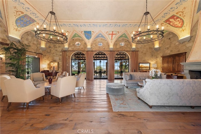 living room with a towering ceiling and wood-type flooring