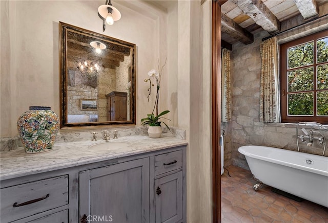 bathroom with wood ceiling, beamed ceiling, a washtub, and vanity