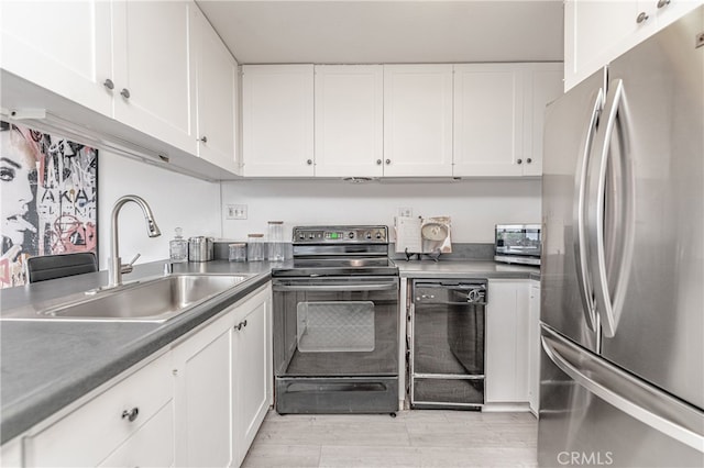 kitchen with light wood-type flooring, black appliances, white cabinetry, and sink