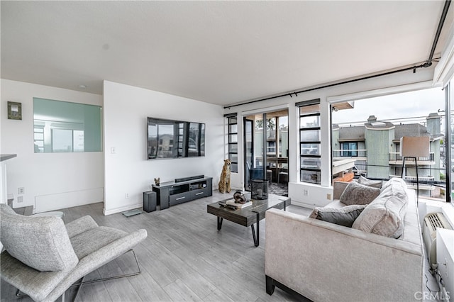 living room featuring light wood-type flooring and a wealth of natural light