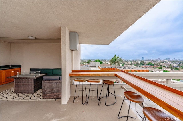 balcony with an outdoor hangout area and a bar