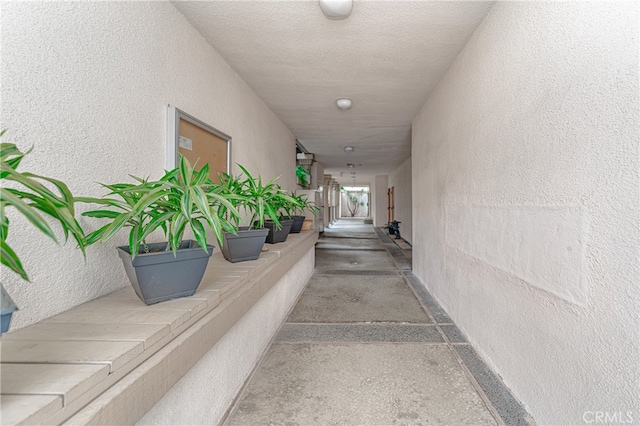 hall with concrete flooring