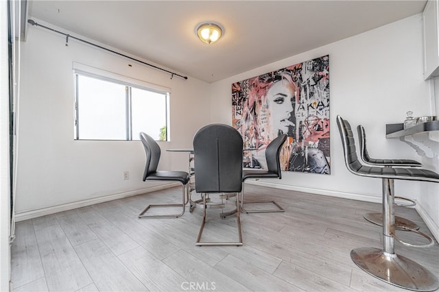 home office with light hardwood / wood-style flooring