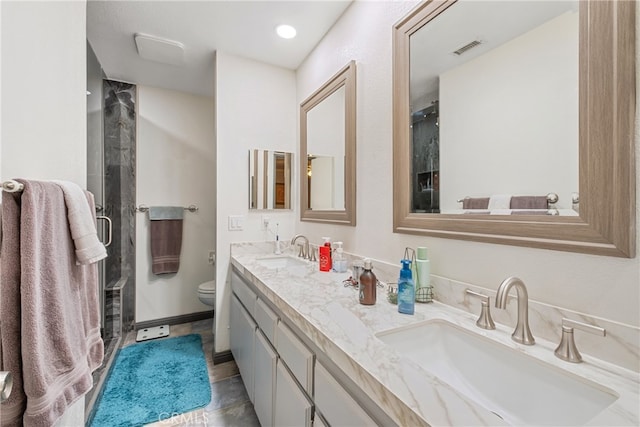 bathroom featuring vanity, toilet, tile patterned floors, and a shower with shower door