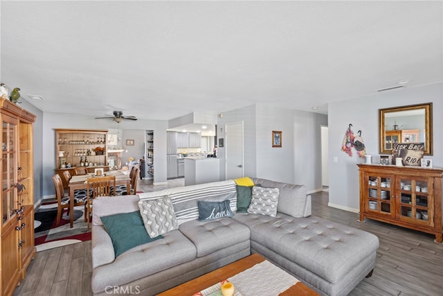 living room with ceiling fan and light hardwood / wood-style flooring