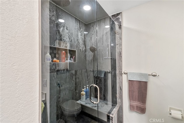 bathroom with walk in shower and toilet