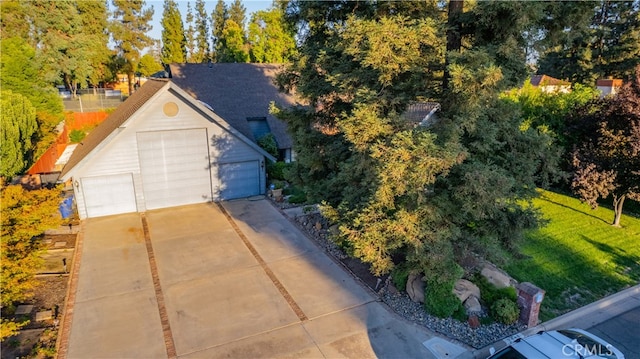 view of front of property with a front lawn, an outbuilding, and a garage