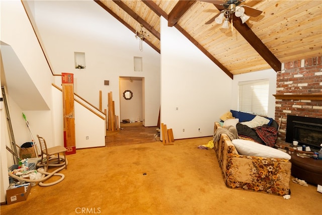 living room featuring beamed ceiling, light colored carpet, high vaulted ceiling, a brick fireplace, and ceiling fan