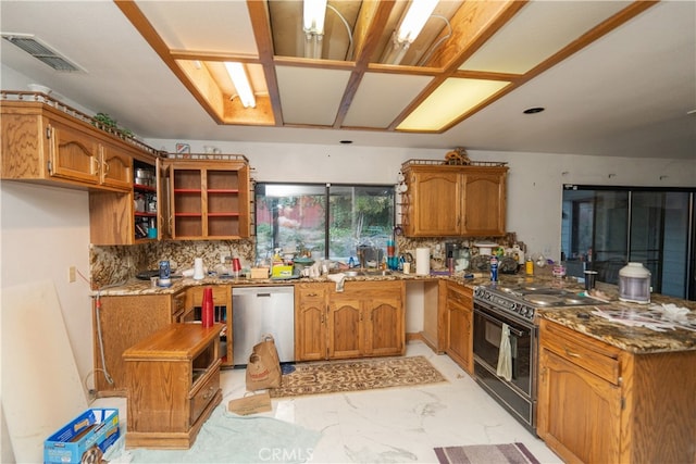 kitchen featuring stone counters, black range oven, decorative backsplash, and stainless steel dishwasher