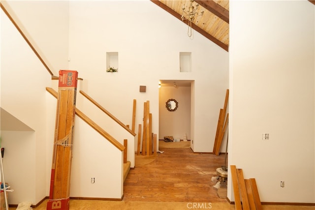 interior space with high vaulted ceiling, wood ceiling, beam ceiling, and hardwood / wood-style floors