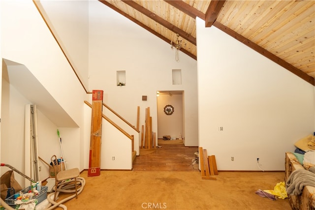 unfurnished living room with wood ceiling, light carpet, beamed ceiling, and high vaulted ceiling