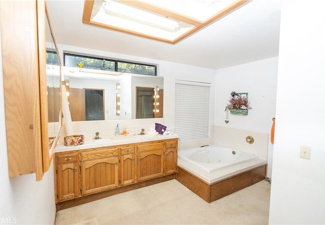 bathroom featuring vanity and tiled bath