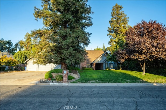 view of front of house featuring a garage and a front lawn