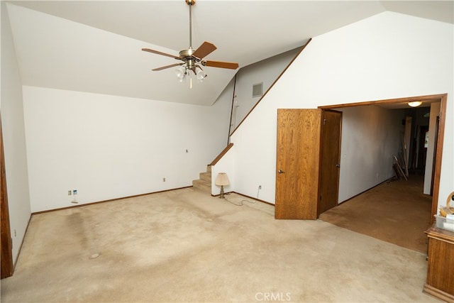 interior space with ceiling fan, light colored carpet, and vaulted ceiling