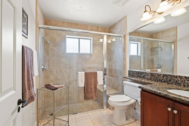 bathroom featuring a wealth of natural light, tile patterned floors, vanity, and walk in shower