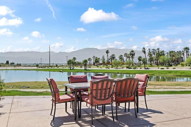 view of patio with a water and mountain view