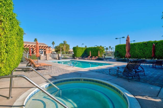 view of pool featuring a patio area and a community hot tub