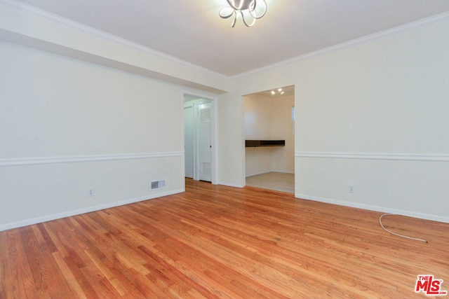 unfurnished room featuring light hardwood / wood-style floors and ornamental molding