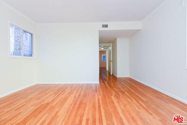 spare room with light hardwood / wood-style floors and ornamental molding