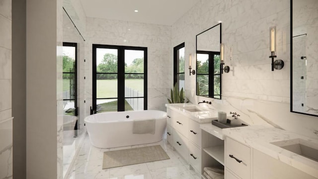 bathroom with a healthy amount of sunlight, tile walls, a tub to relax in, and vanity