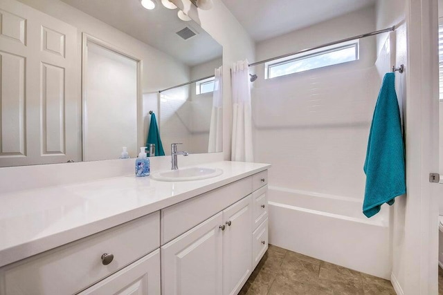 full bathroom with vanity, shower / tub combo, and toilet