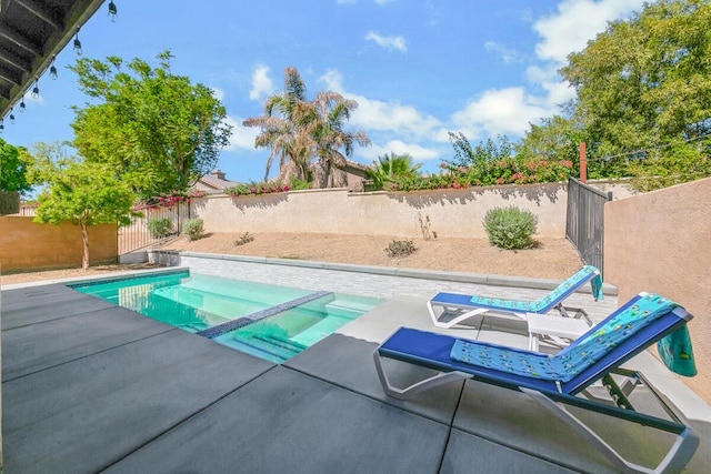 view of swimming pool featuring an in ground hot tub and a patio