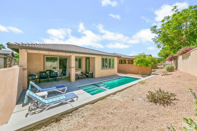 back of house with a patio and a fenced in pool