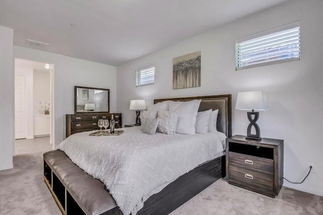 carpeted bedroom with ensuite bath