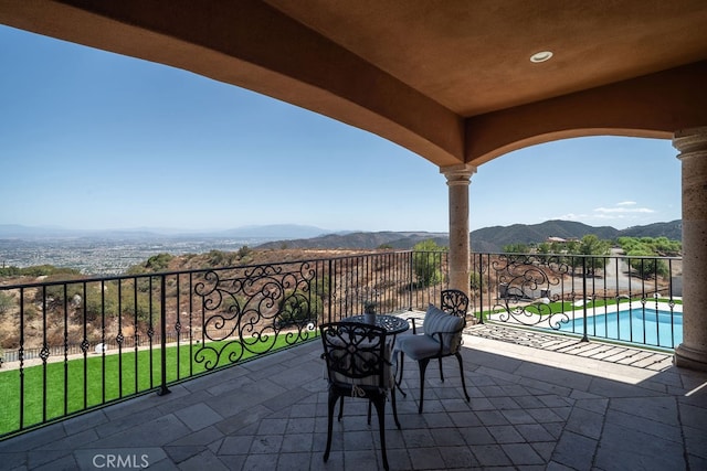 view of patio / terrace with a mountain view and a fenced in pool