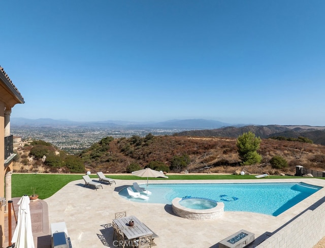 view of pool with a mountain view, an in ground hot tub, and a patio area