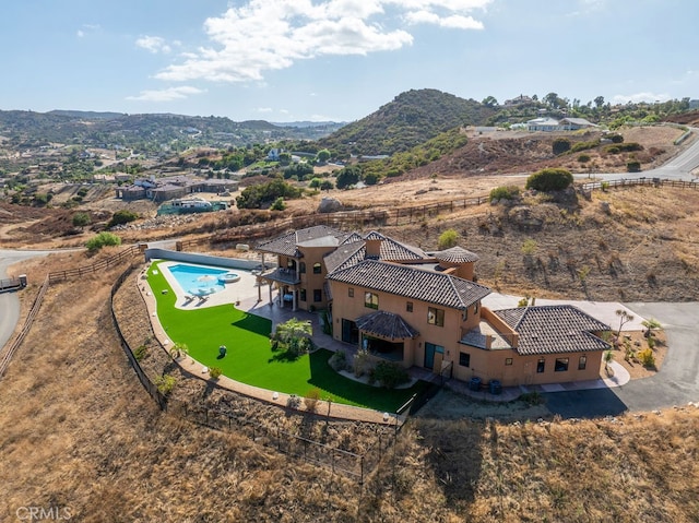 birds eye view of property with a mountain view