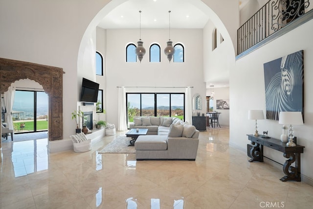 living room featuring a high ceiling and a chandelier